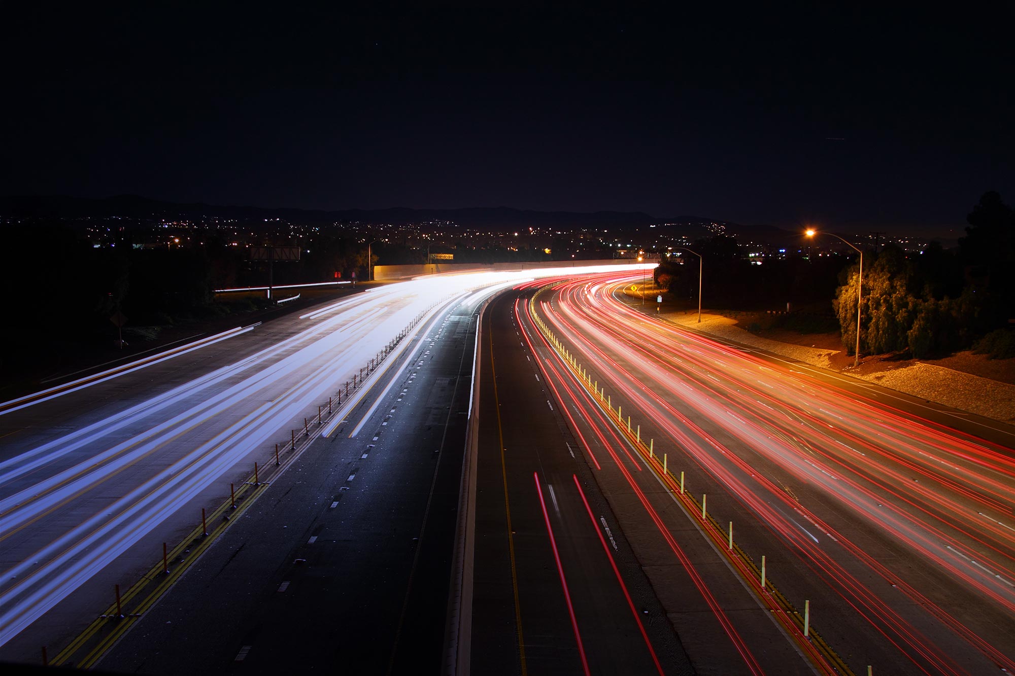 Highway at night with blurred headlights from a distance